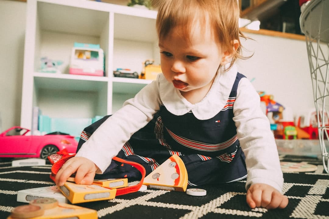 Toddler playing with toy in bright playroom