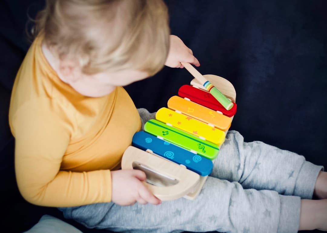 Child with rainbow xylophone